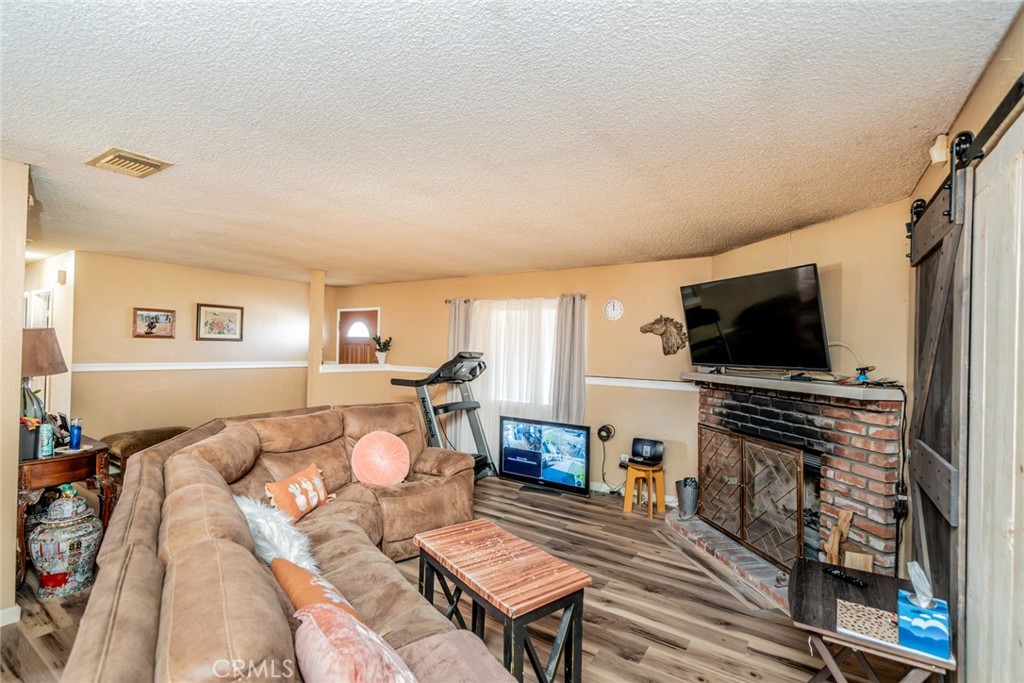 4637 Luna Road Phelan, CA 92371 - Photo 14 of 43 a living room with furniture and a flat screen tv