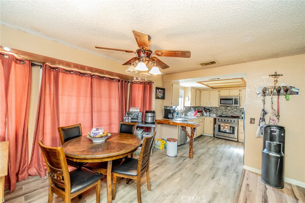 4637 Luna Road Phelan, CA 92371 - Photo 15 of 43 a view of a dining room with furniture window and wooden floor