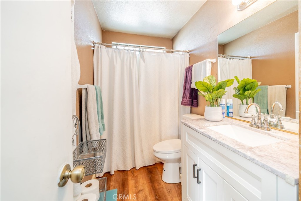 4637 Luna Road Phelan, CA 92371 - Photo 21 of 43 a bathroom with a granite countertop sink and a mirror