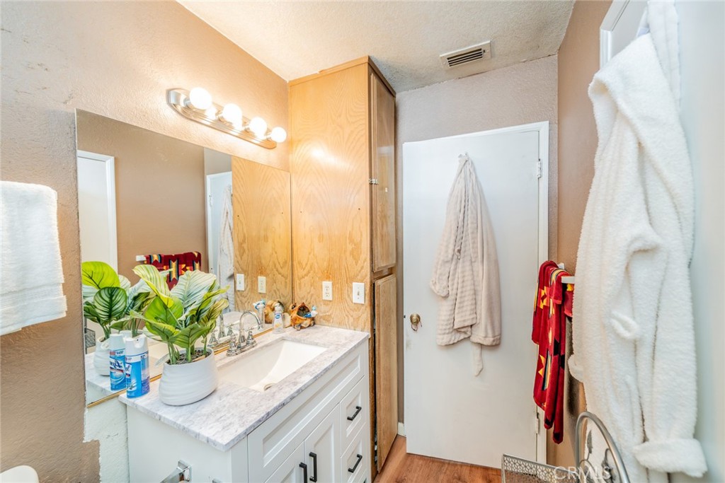 4637 Luna Road Phelan, CA 92371 - Photo 22 of 43 a view of bathroom with a tub sink a mirror and a shower