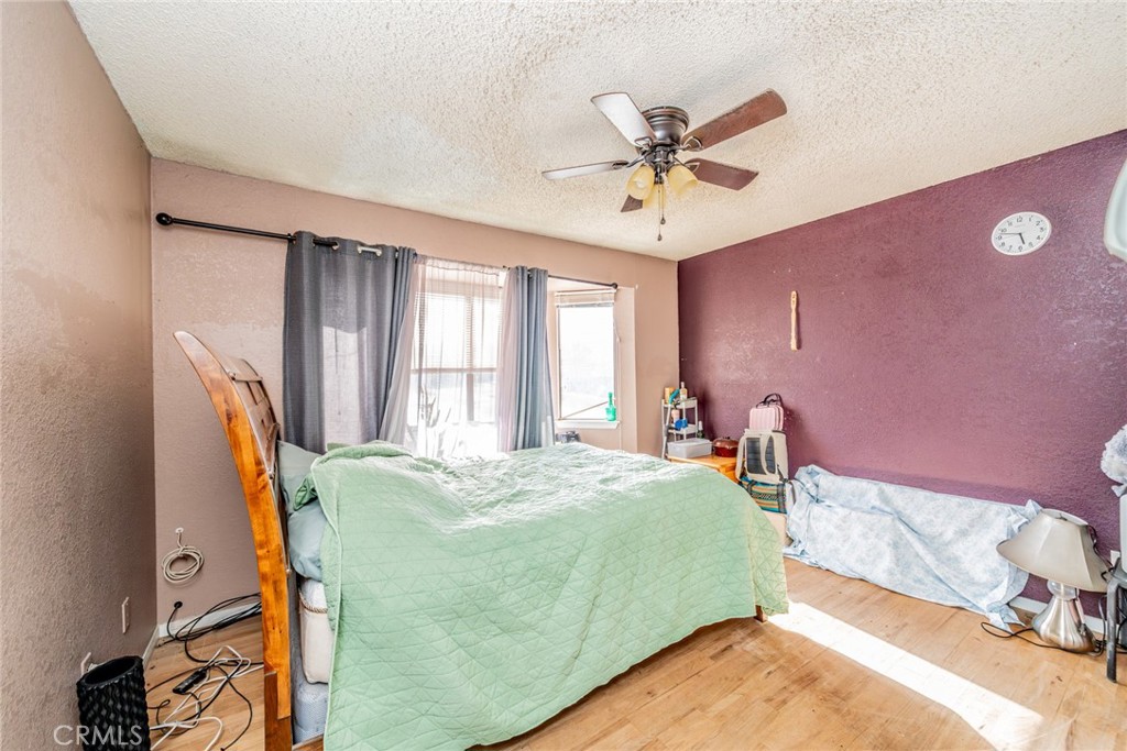 4637 Luna Road Phelan, CA 92371 - Photo 26 of 43 a bedroom with a bed and window