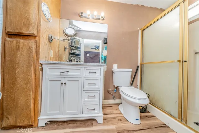 a bathroom with a sink a toilet a shower and a mirror