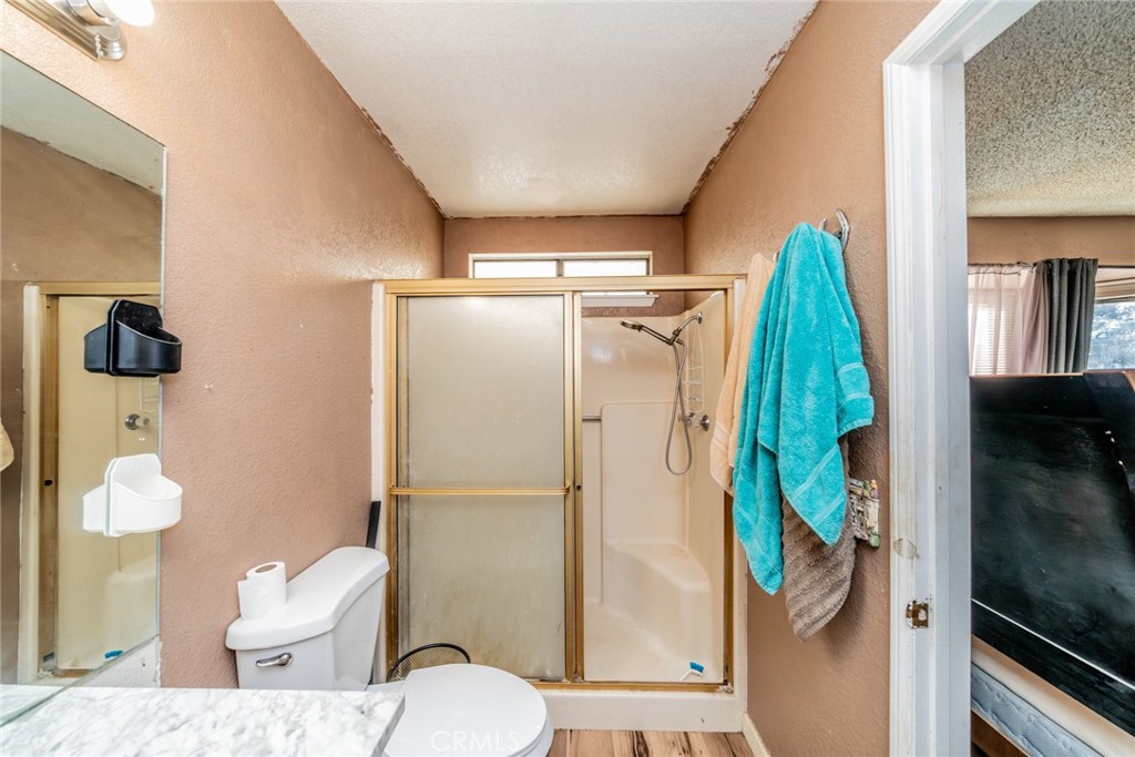 4637 Luna Road Phelan, CA 92371 - Photo 30 of 43 a bathroom with a toilet and a shower