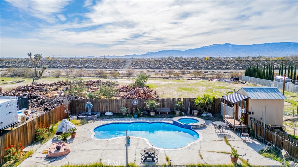4637 Luna Road Phelan, CA 92371 - Photo 38 of 43 a view of a swimming pool with a table and chairs
