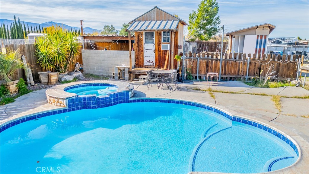 4637 Luna Road Phelan, CA 92371 - Photo 43 of 43 a view of a house with backyard and swimming pool