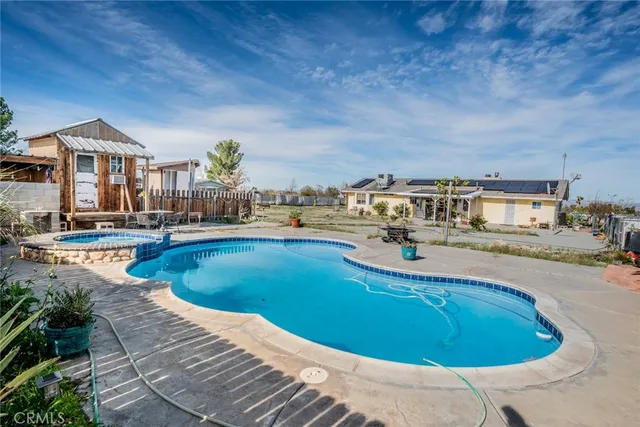 a view of a swimming pool with outdoor seating