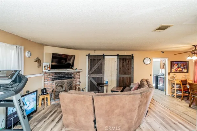 a living room with fireplace furniture and a flat screen tv