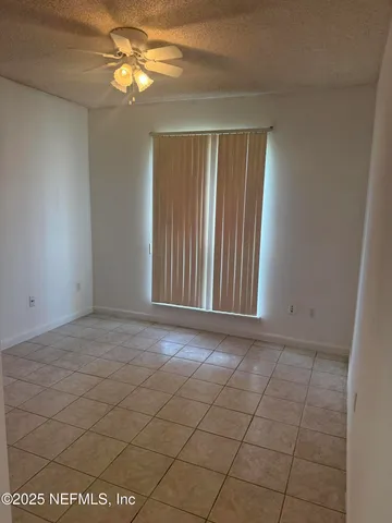 a view of a livingroom with a chandelier fan