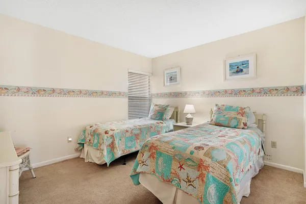 a bedroom with a bed and a dresser in it