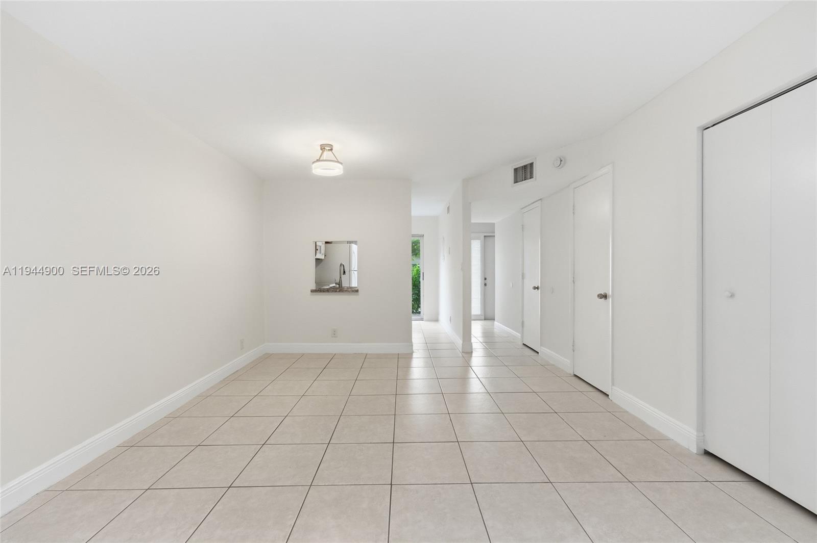 3003 Northwest 5th Terrace, Unit 2 Pompano Beach, FL 33064 - Photo 12 of 28 a view of an empty room with a window