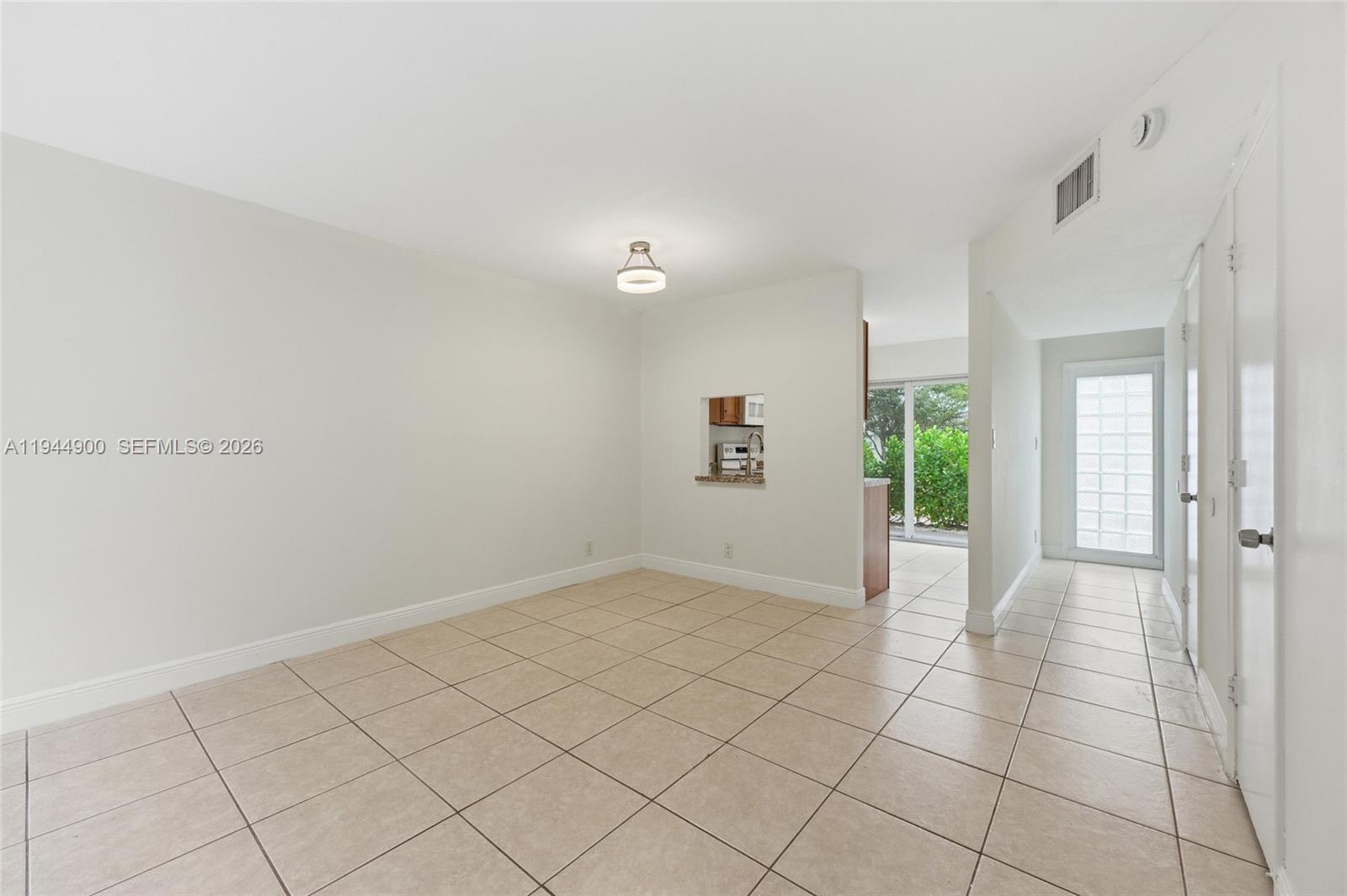 3003 Northwest 5th Terrace, Unit 2 Pompano Beach, FL 33064 - Photo 13 of 28 a view of an empty room and window