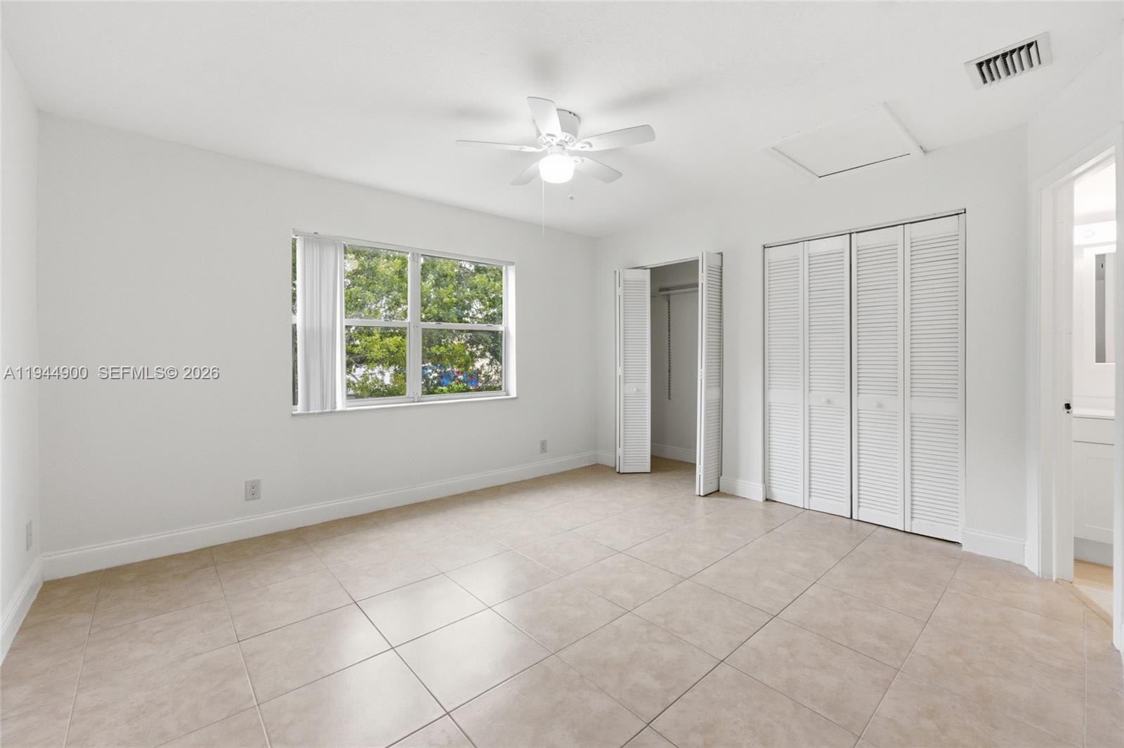 3003 Northwest 5th Terrace, Unit 2 Pompano Beach, FL 33064 - Photo 18 of 28 an empty room with windows and closet