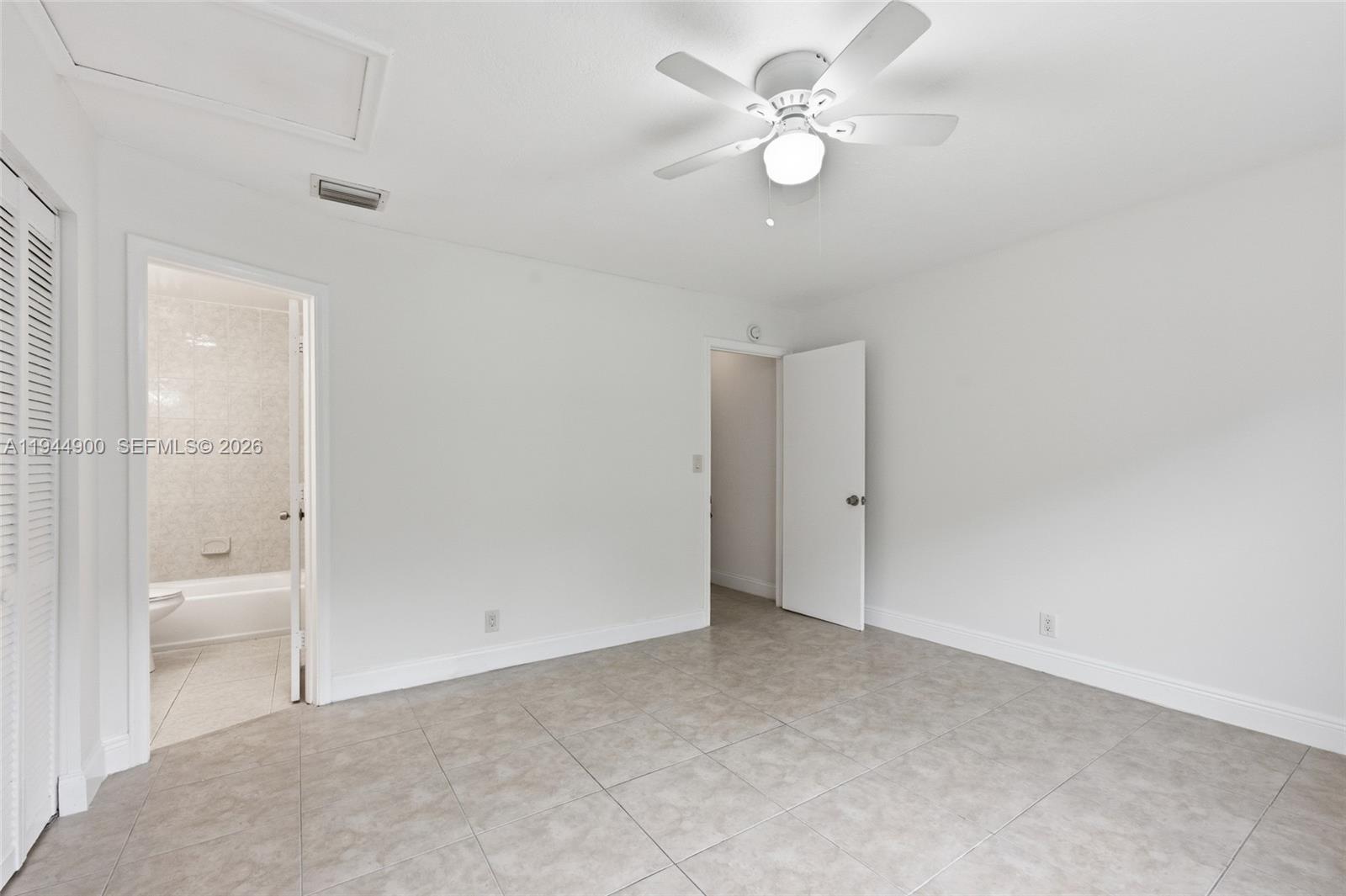 3003 Northwest 5th Terrace, Unit 2 Pompano Beach, FL 33064 - Photo 20 of 28 wooden floor in an empty room with a bathroom