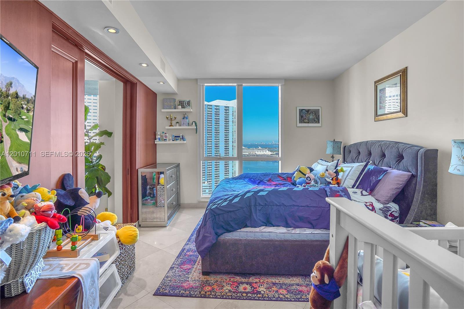 901 Brickell Key Boulevard, Unit 2807 Miami, FL 33131 - Photo 14 of 29 a living room with furniture toys and a window