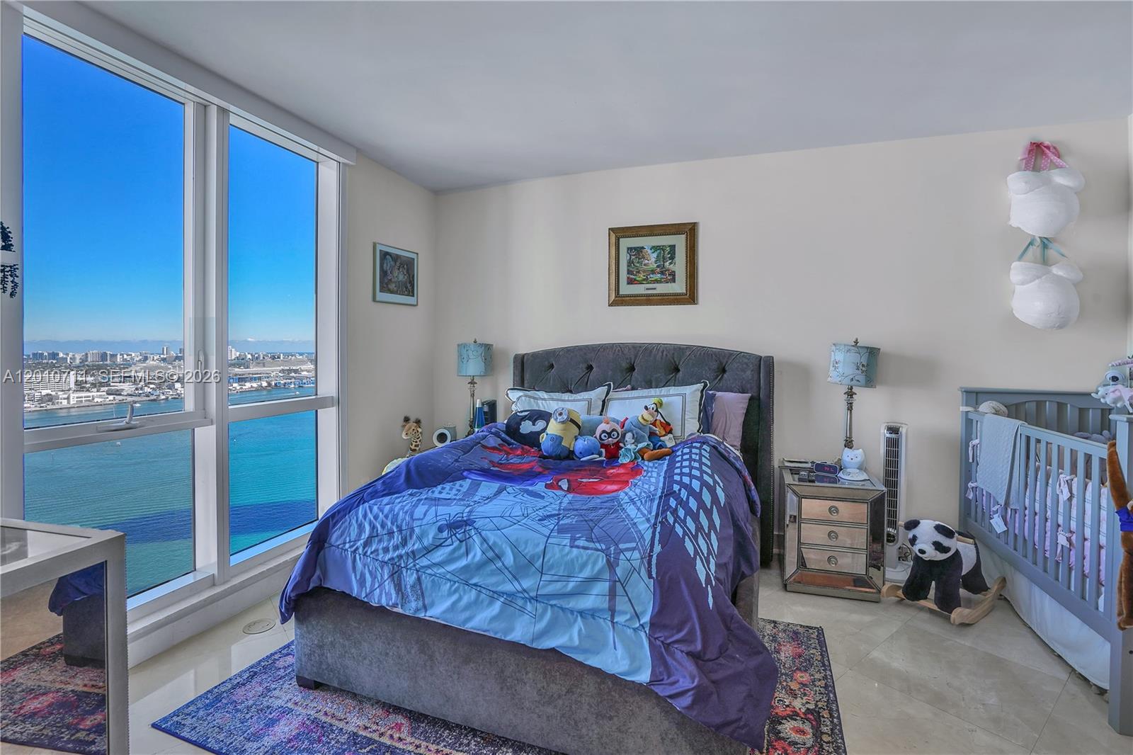 901 Brickell Key Boulevard, Unit 2807 Miami, FL 33131 - Photo 15 of 29 a bedroom with a bed and a window