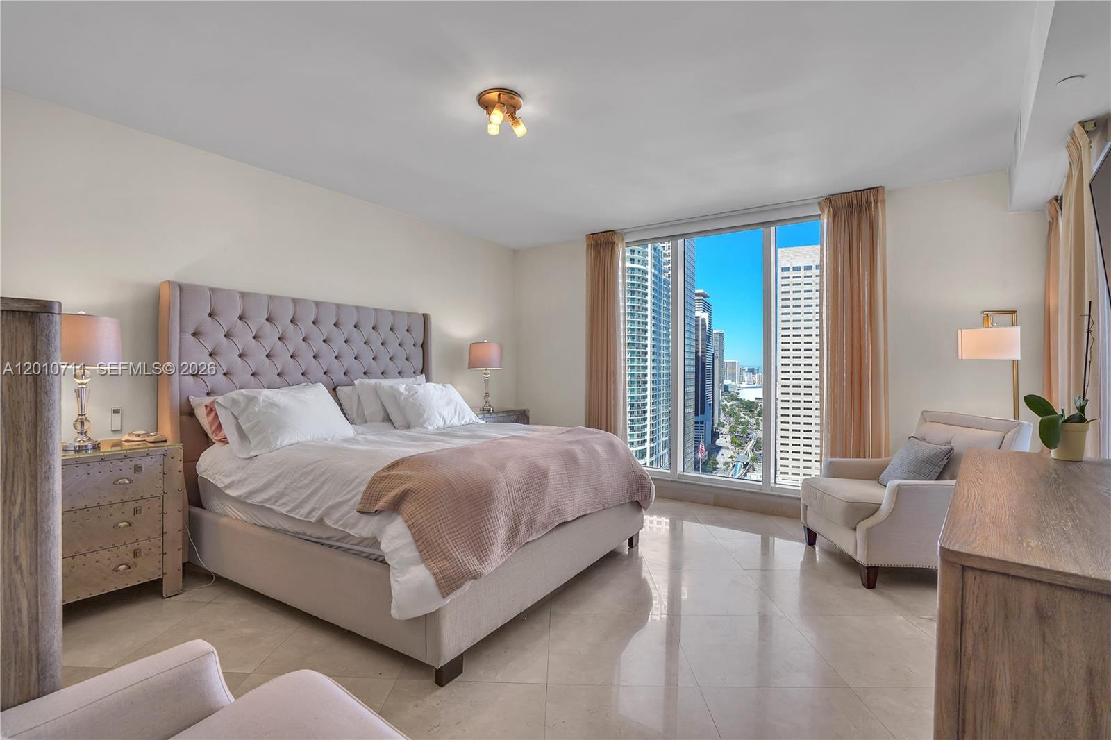 901 Brickell Key Boulevard, Unit 2807 Miami, FL 33131 - Photo 16 of 29 a bed room with a bed and a couch