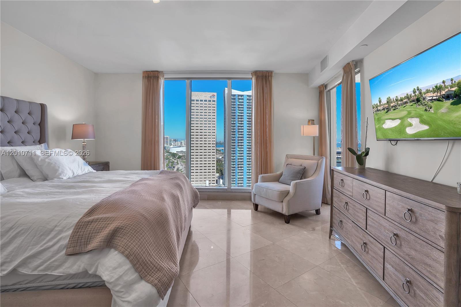 901 Brickell Key Boulevard, Unit 2807 Miami, FL 33131 - Photo 17 of 29 a bedroom with a bed and couch