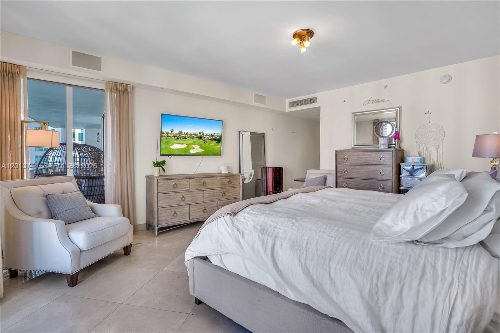 901 Brickell Key Boulevard, Unit 2807 Miami, FL 33131 - Photo 18 of 29 a bedroom with bed and window