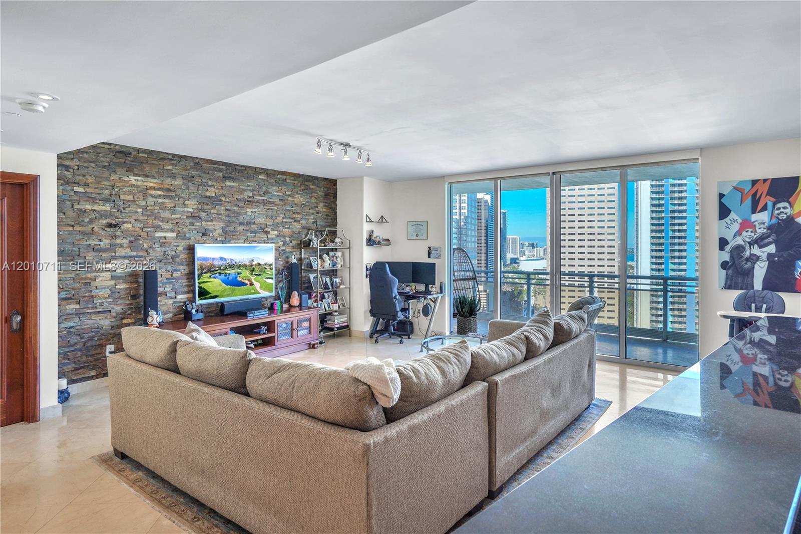 901 Brickell Key Boulevard, Unit 2807 Miami, FL 33131 - Photo 22 of 29 a living room with fireplace furniture and a flat screen tv