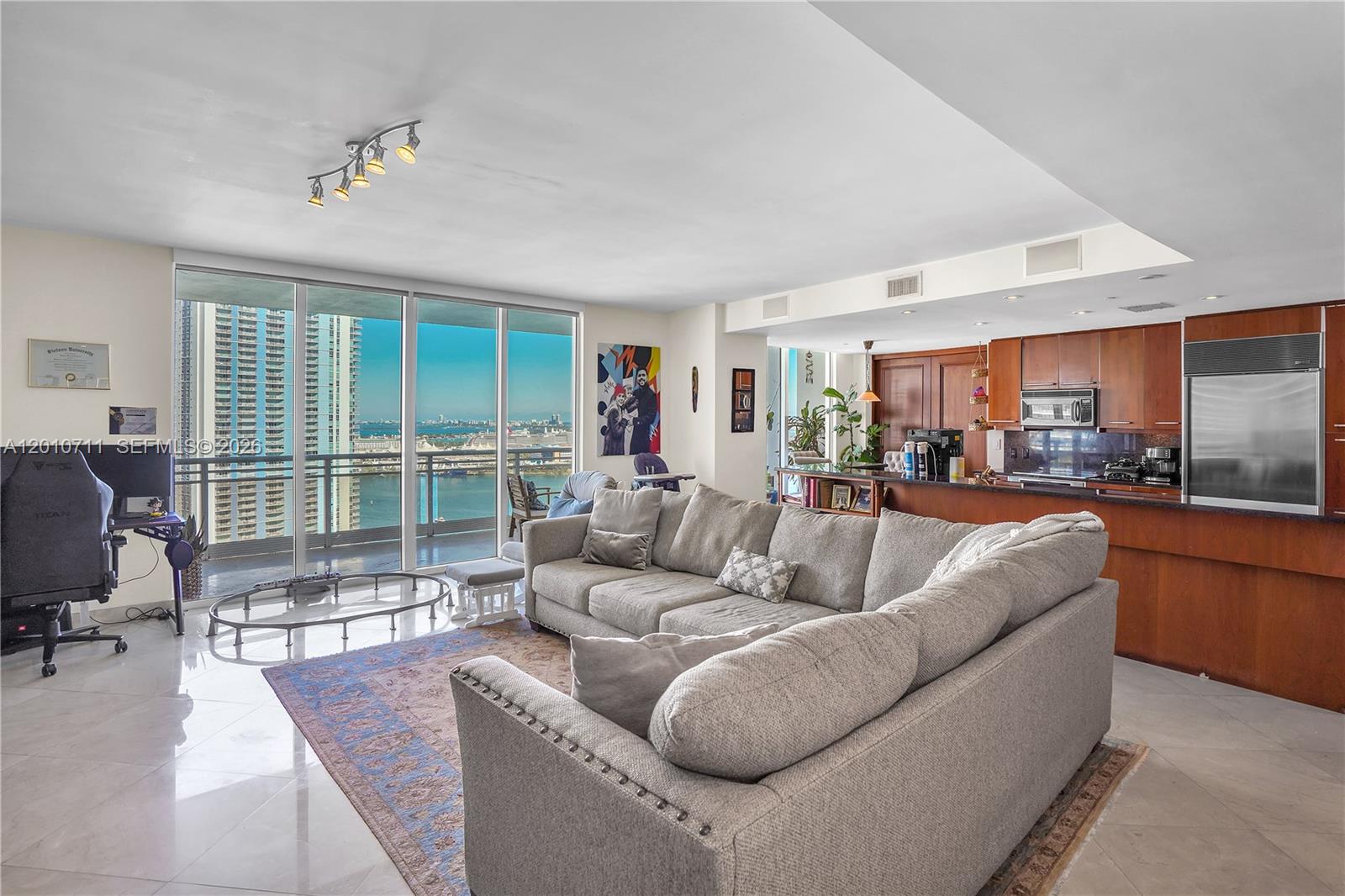 901 Brickell Key Boulevard, Unit 2807 Miami, FL 33131 - Photo 24 of 29 a living room with furniture and a large window