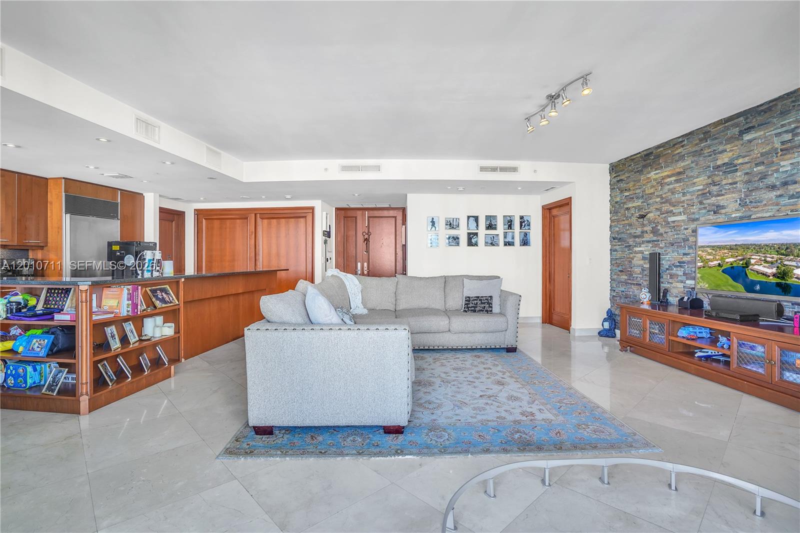 901 Brickell Key Boulevard, Unit 2807 Miami, FL 33131 - Photo 25 of 29 a living room with furniture and a flat screen tv