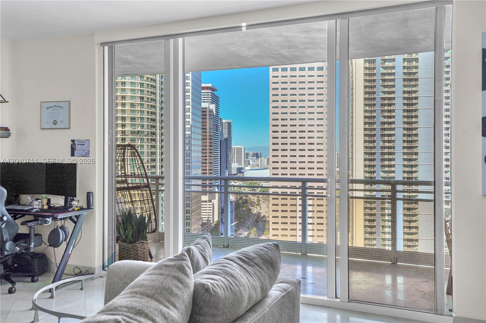 901 Brickell Key Boulevard, Unit 2807 Miami, FL 33131 - Photo 27 of 29 a living room with furniture and a flat screen tv