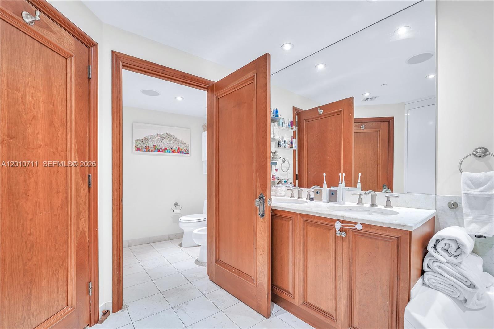 901 Brickell Key Boulevard, Unit 2807 Miami, FL 33131 - Photo 29 of 29 a bathroom with a sink a toilet and shower