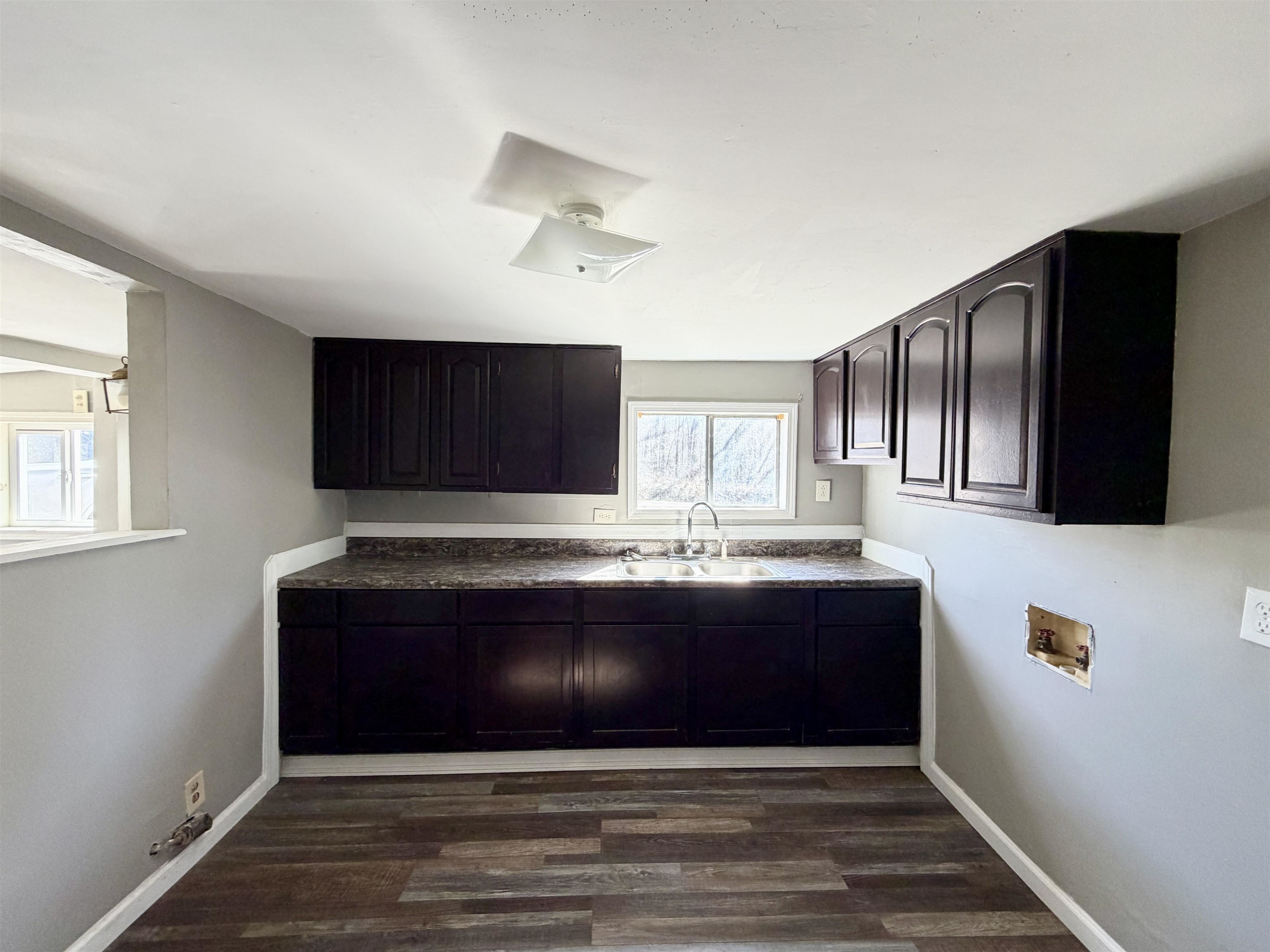 345 Shad Lane Adamsville, TN 38310 - Photo 7 of 20 Kitchen with dark wood finished floors and dark countertops