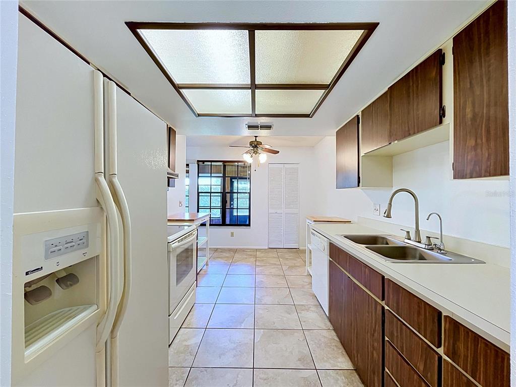 9319 Trowbridge Court New Port Richey, FL 34655 - Photo 33 of 78 a kitchen with stainless steel appliances granite countertop a sink and a refrigerator