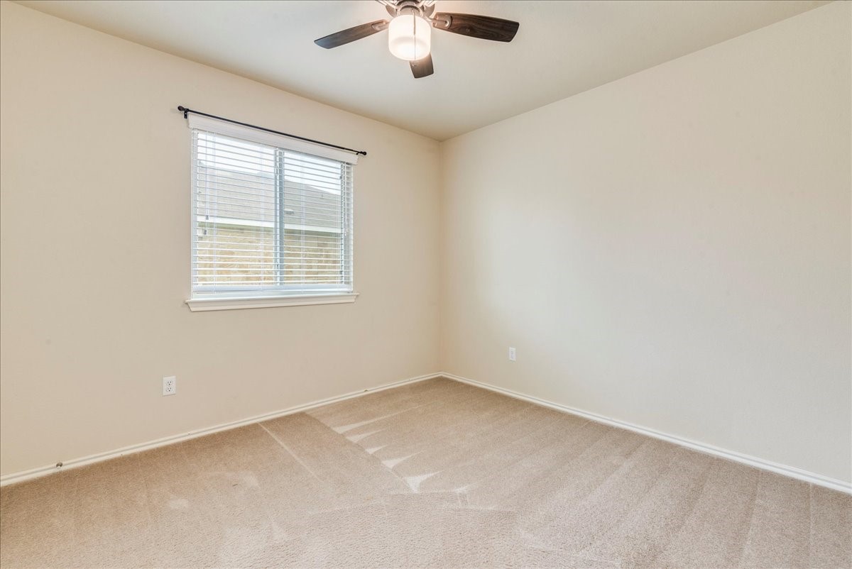 1061 Violet Lane Kyle, TX 78640 - Photo 17 of 34 third bedroom with view of window and ceiling light/fan