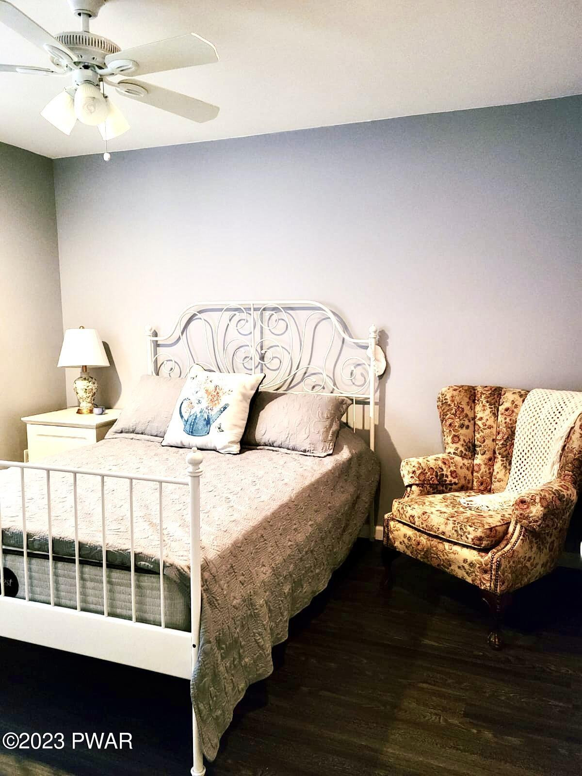 146 Roundhill Road Dingmans Ferry, PA 18328 - Photo 27 of 53 a bedroom with a bed and a large window