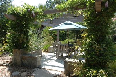 1853 Meiners Road Ojai, CA 93023 - Photo 5 of 9 a patio with table and chairs under an umbrella