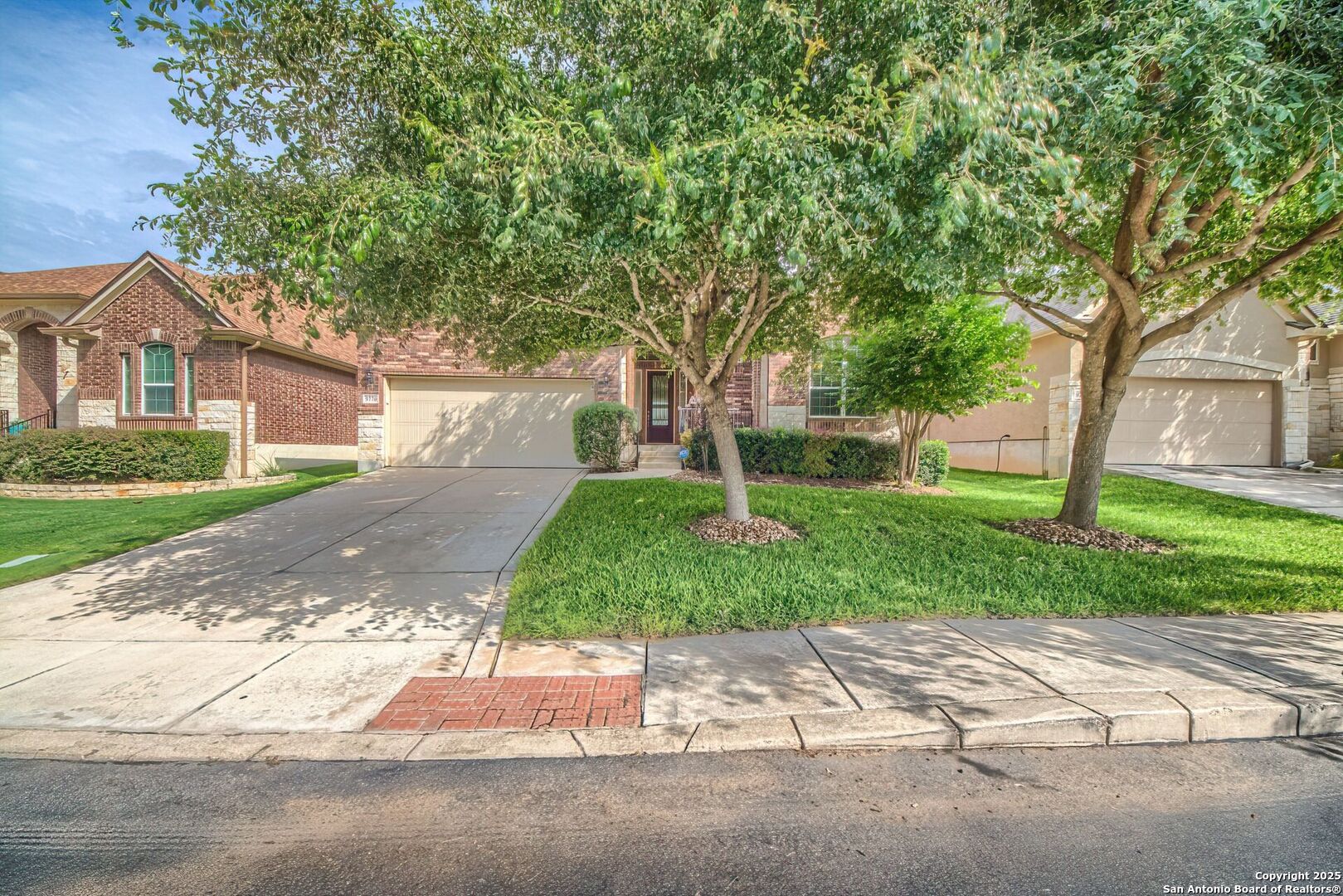 a front view of a house with a yard and a garage