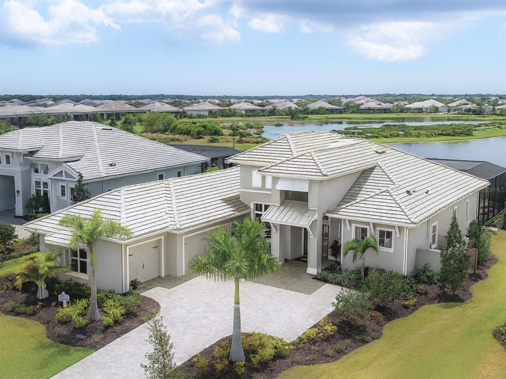 8477 Pavia Way Lakewood Ranch, FL 34202 - Photo 1 of 67 a view of a house with a garden and lake view