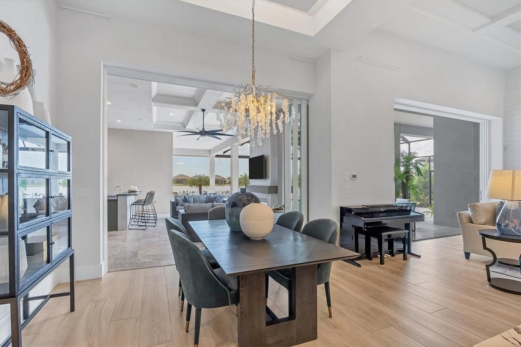 8477 Pavia Way Lakewood Ranch, FL 34202 - Photo 11 of 67 a view of a dining room with furniture window and wooden floor