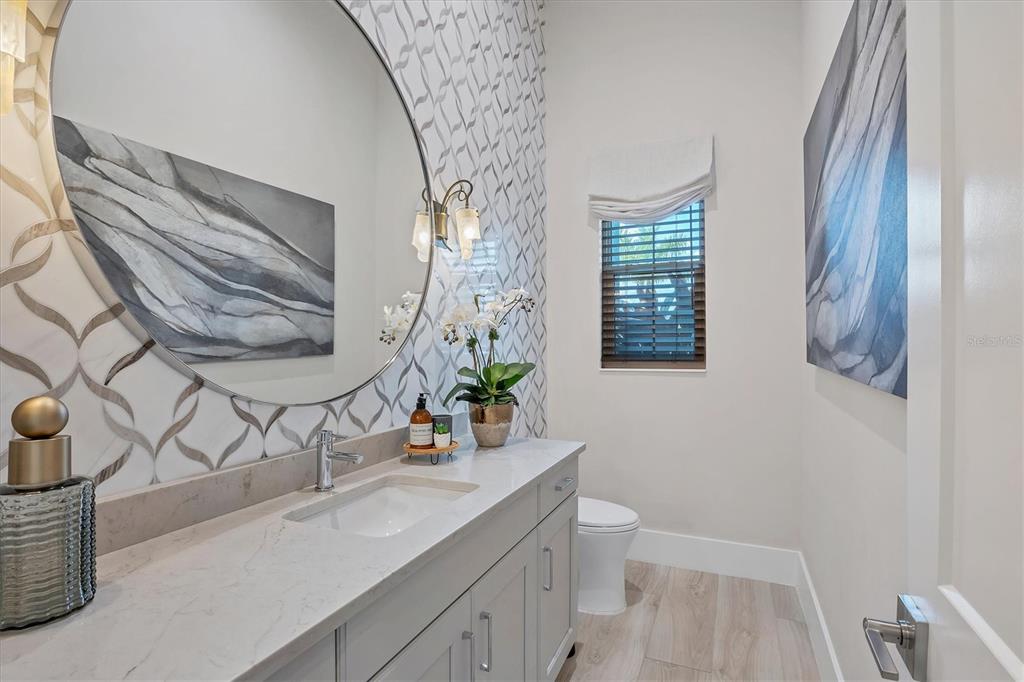 8477 Pavia Way Lakewood Ranch, FL 34202 - Photo 15 of 67 a bathroom with a sink a toilet and mirror