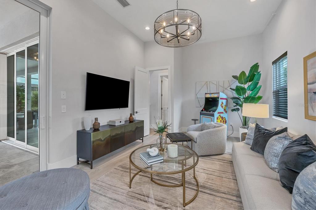 8477 Pavia Way Lakewood Ranch, FL 34202 - Photo 16 of 67 a living room with furniture and a flat screen tv