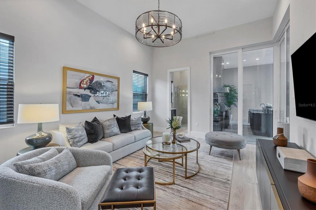 8477 Pavia Way Lakewood Ranch, FL 34202 - Photo 17 of 67 a living room with furniture a flat screen tv and couches