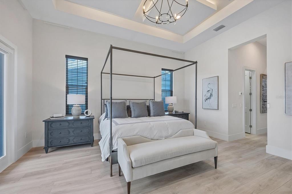 8477 Pavia Way Lakewood Ranch, FL 34202 - Photo 19 of 67 a living room with furniture and a chandelier