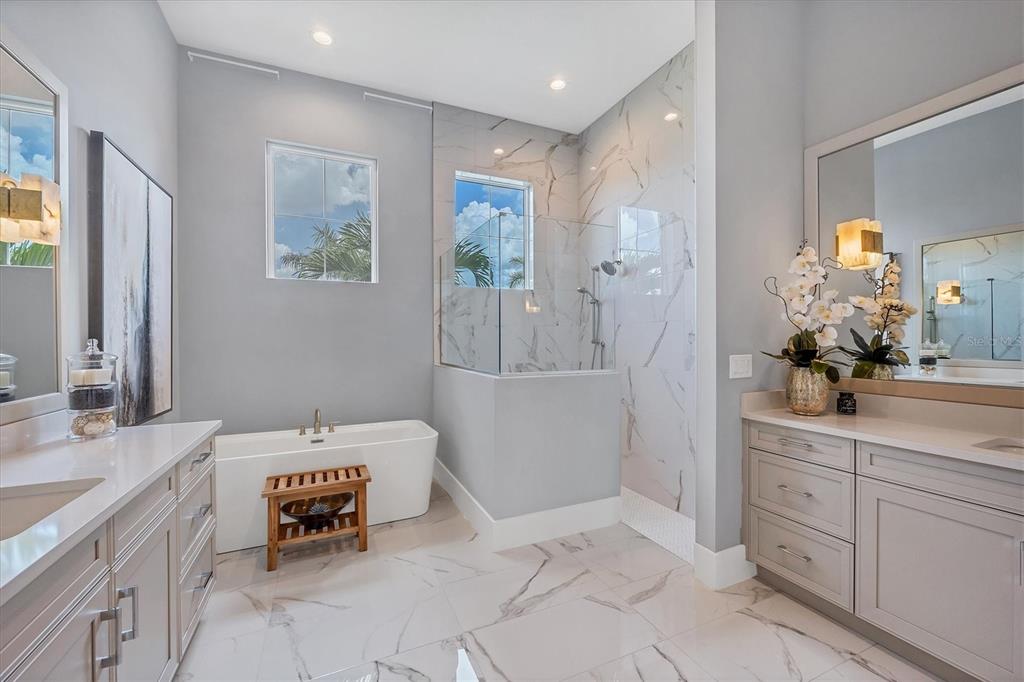 8477 Pavia Way Lakewood Ranch, FL 34202 - Photo 22 of 67 a spacious bathroom with a double vanity sink a mirror and a bathtub