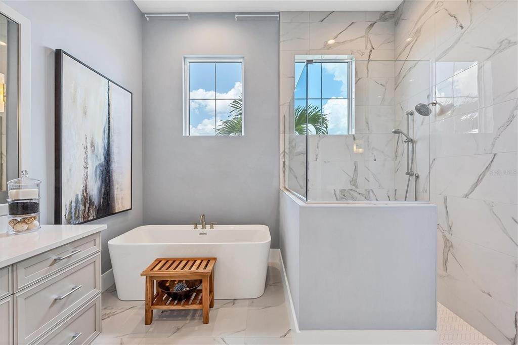 8477 Pavia Way Lakewood Ranch, FL 34202 - Photo 23 of 67 a spacious bathroom with a granite countertop sink and a mirror