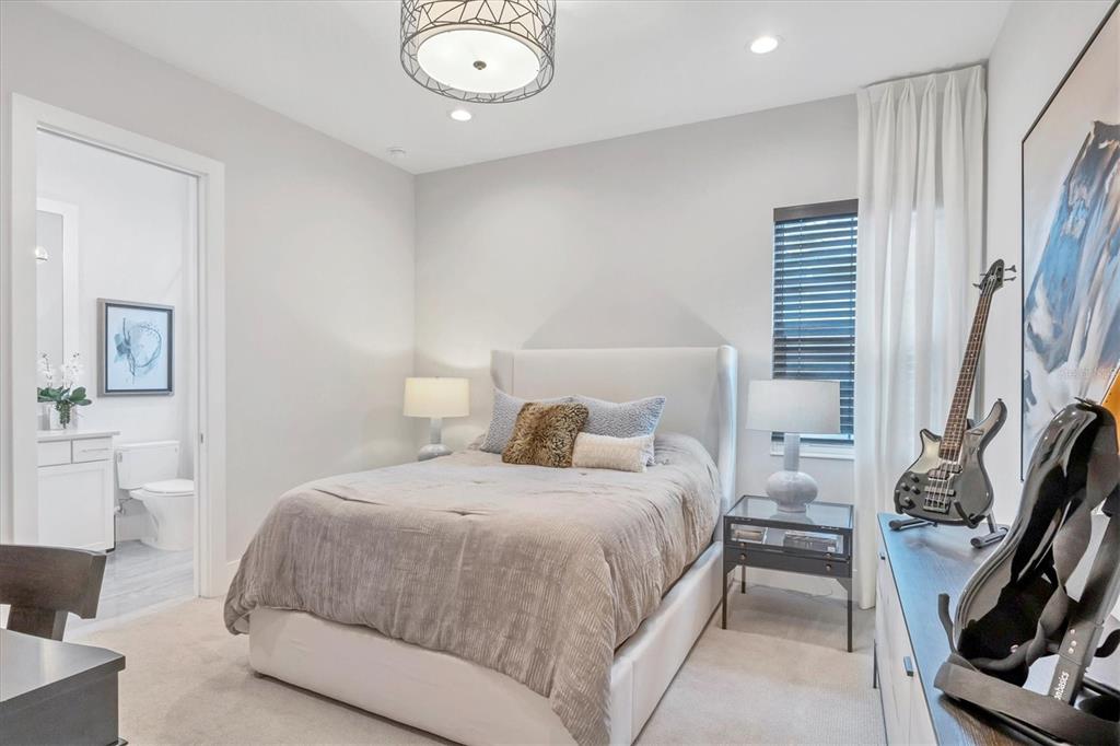 8477 Pavia Way Lakewood Ranch, FL 34202 - Photo 24 of 67 a bedroom with a bed and a flat screen tv