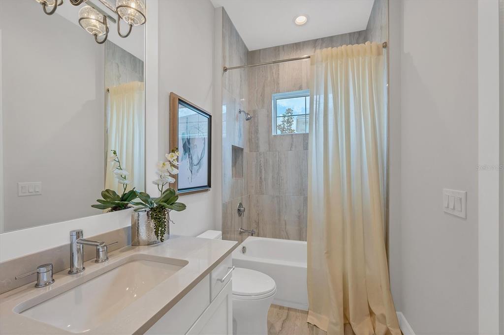 8477 Pavia Way Lakewood Ranch, FL 34202 - Photo 25 of 67 a bathroom with a sink a toilet and shower