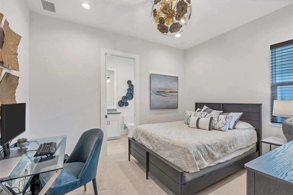 8477 Pavia Way Lakewood Ranch, FL 34202 - Photo 26 of 67 a bedroom with a bed and a chair