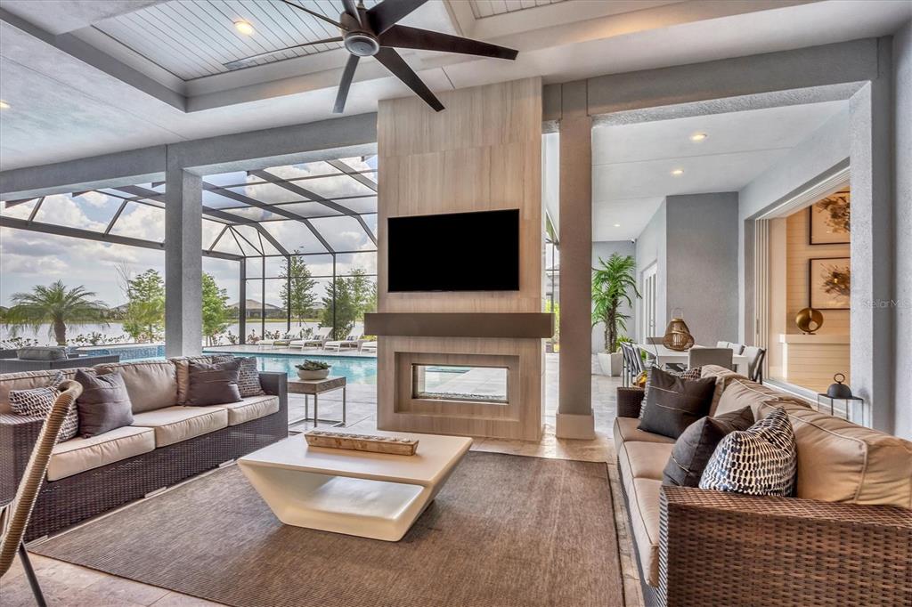 8477 Pavia Way Lakewood Ranch, FL 34202 - Photo 29 of 67 a living room with furniture fireplace and a flat screen tv