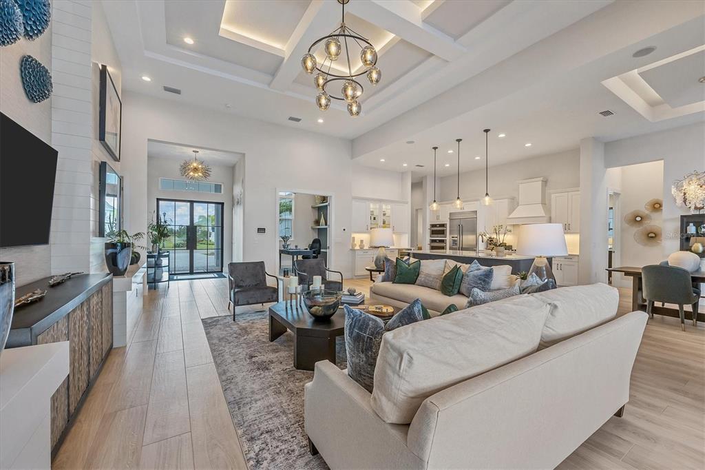 8477 Pavia Way Lakewood Ranch, FL 34202 - Photo 3 of 67 a living room with lots of furniture and a flat screen tv