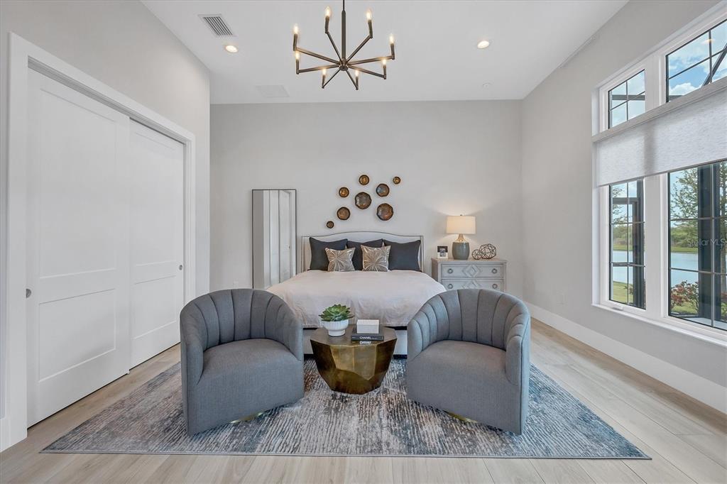 8477 Pavia Way Lakewood Ranch, FL 34202 - Photo 37 of 67 a living room with furniture a chandelier and a window