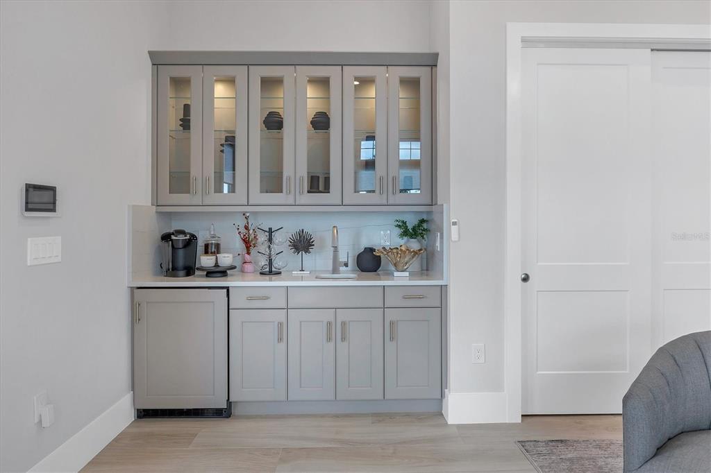 8477 Pavia Way Lakewood Ranch, FL 34202 - Photo 39 of 67 a bathroom with granite countertop white cabinets and a sink