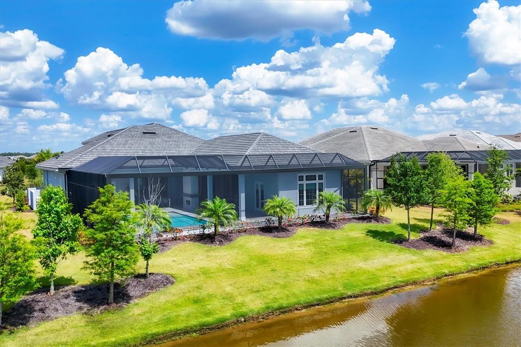 8477 Pavia Way Lakewood Ranch, FL 34202 - Photo 49 of 67 a view of a house with swimming pool and sitting area
