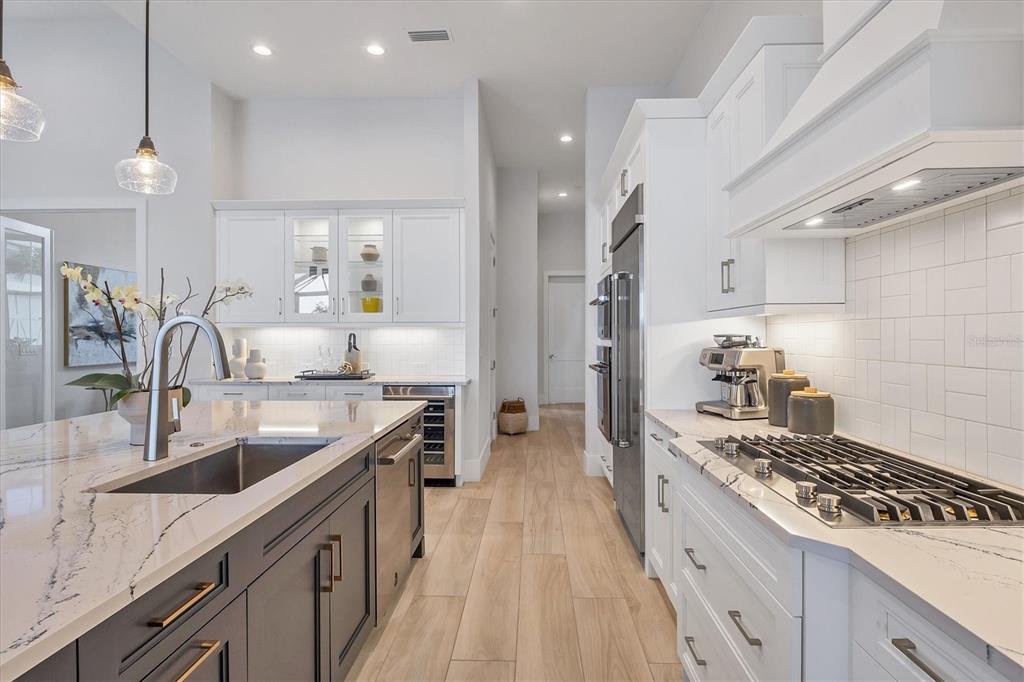 8477 Pavia Way Lakewood Ranch, FL 34202 - Photo 9 of 67 a kitchen with granite countertop a sink stove and cabinets